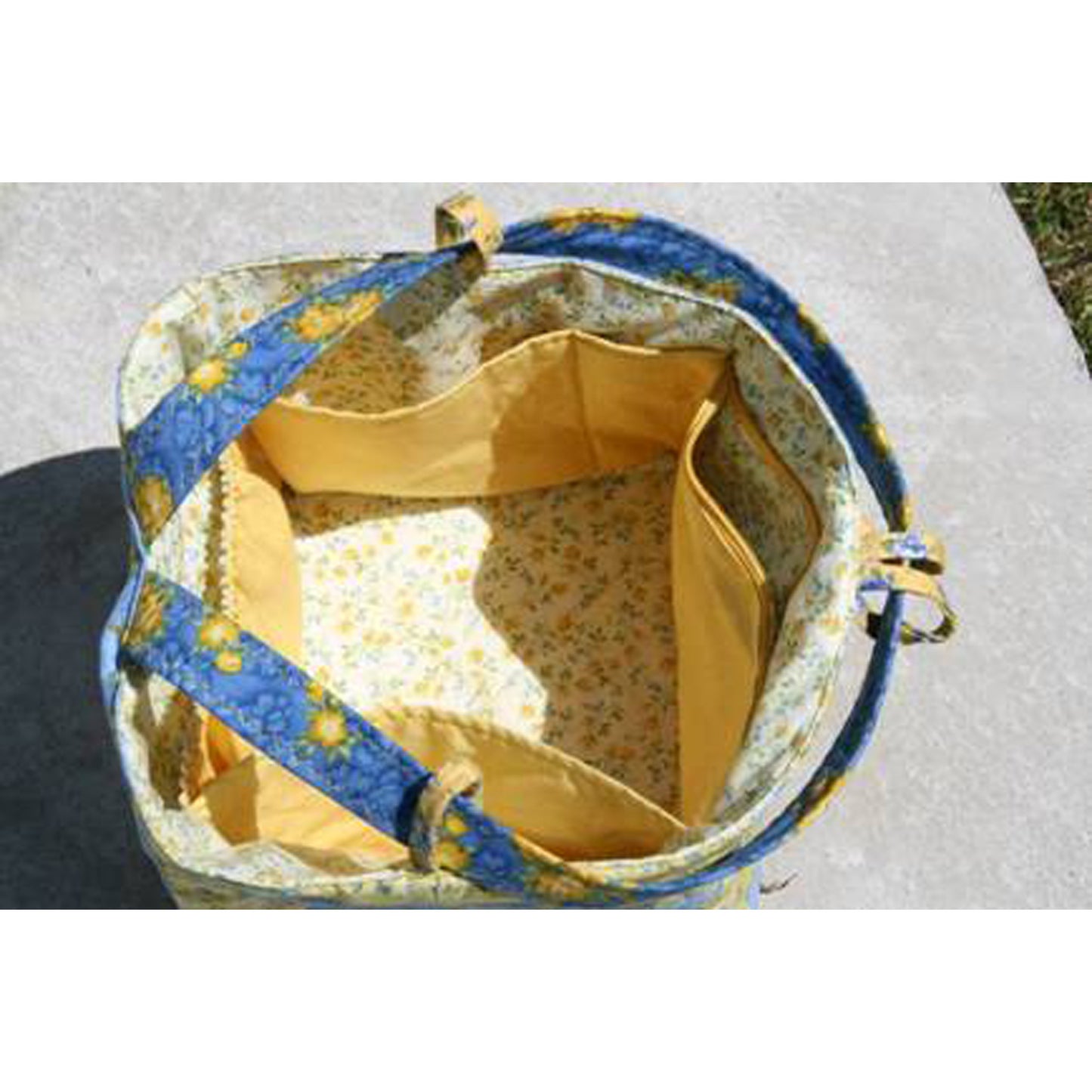 Fabric basket with blue and yellow pattern on a white background
