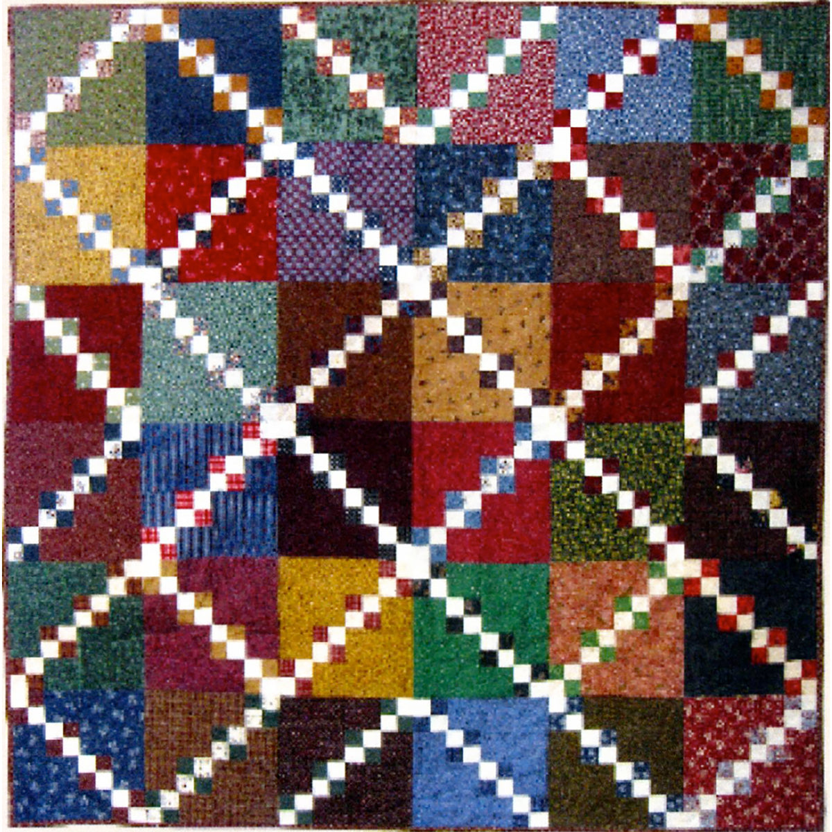 Colorful quilt with a patchwork pattern featuring various geometric shapes.