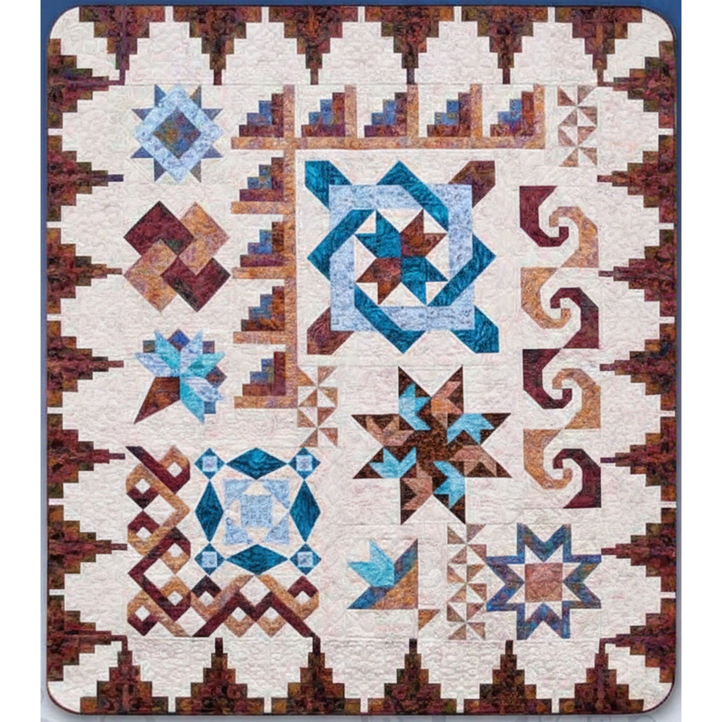 Nancy's Fancy quilt by Black Cat Creations with geometric pattern featuring stars and swirls in brown, blue, and white.