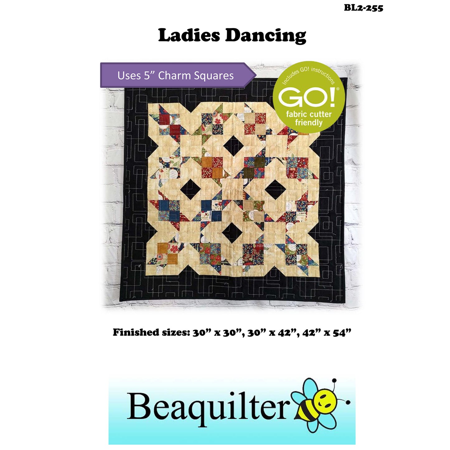 Charming quilt showcases a beautiful patchwork design with note about this pattern being Accuquilt GO! fabric cutter friendly and that it uses 5-inch charm squares.