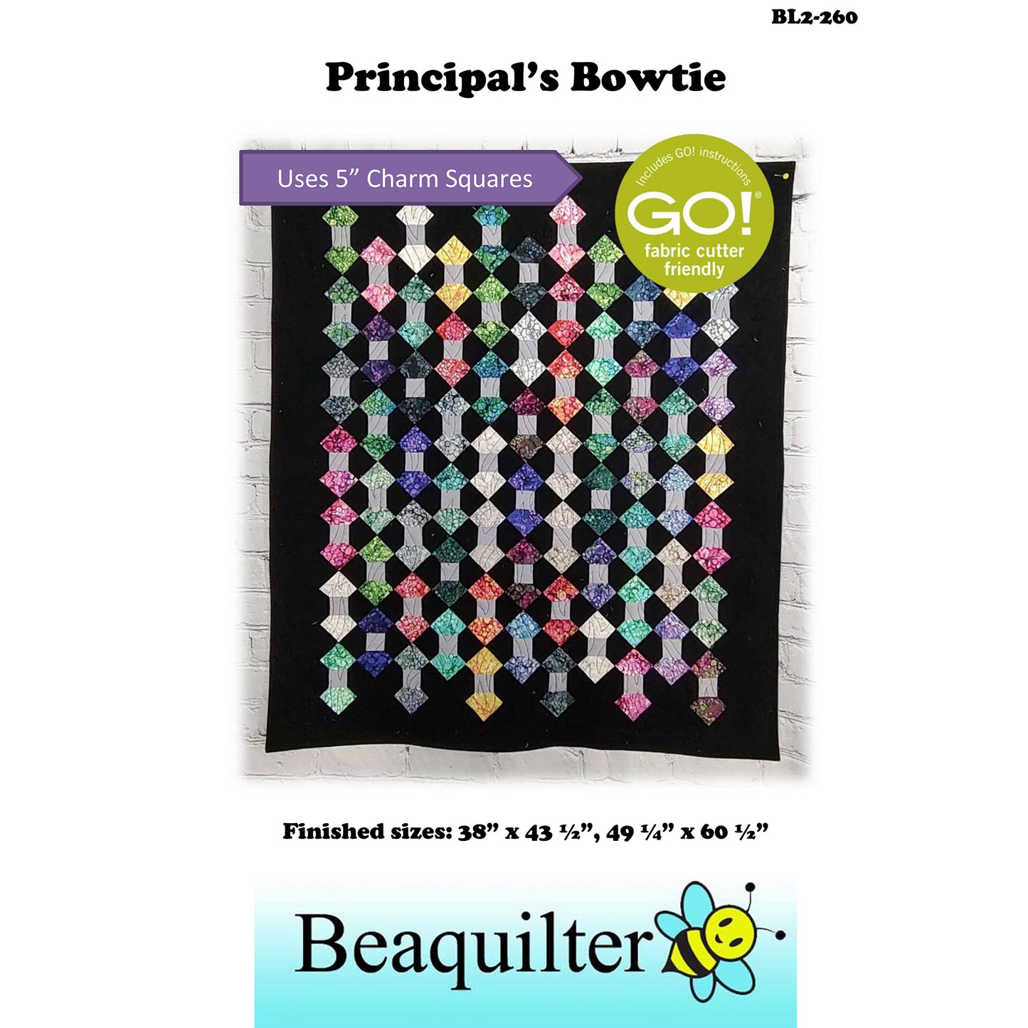 Colorful quilt is scrappy with rows and columns of two diamonds attached by a small strip of gray fabric. Makes it look like bowties or could be skeins of yarn.