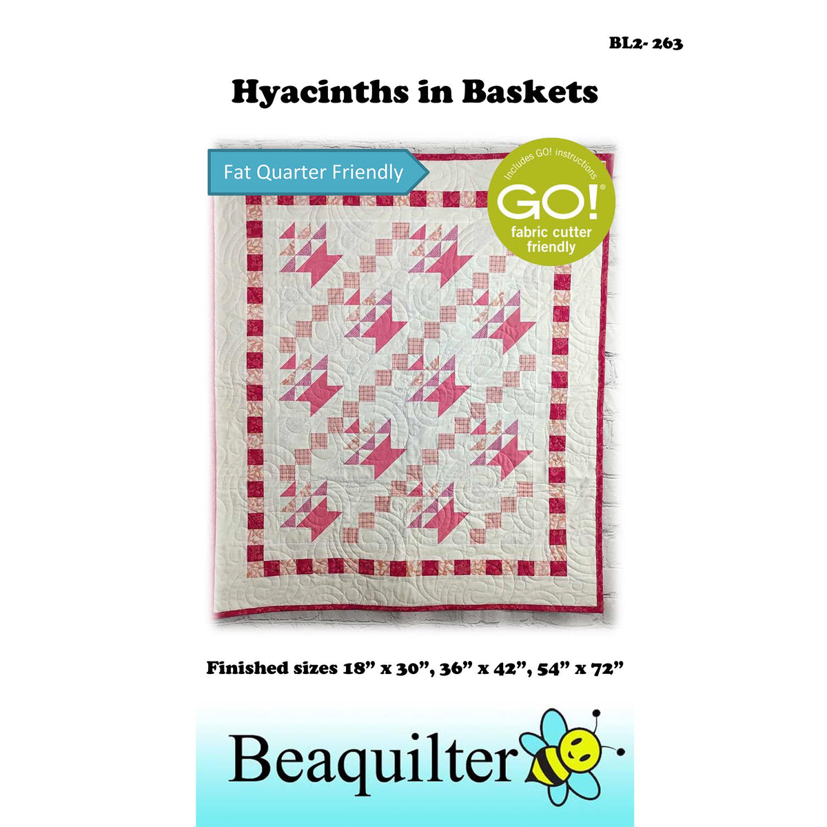 Pink and White quilt with baskets in diagonal rows with upside down triangles inside to make them look like flowers and a border of small squares.