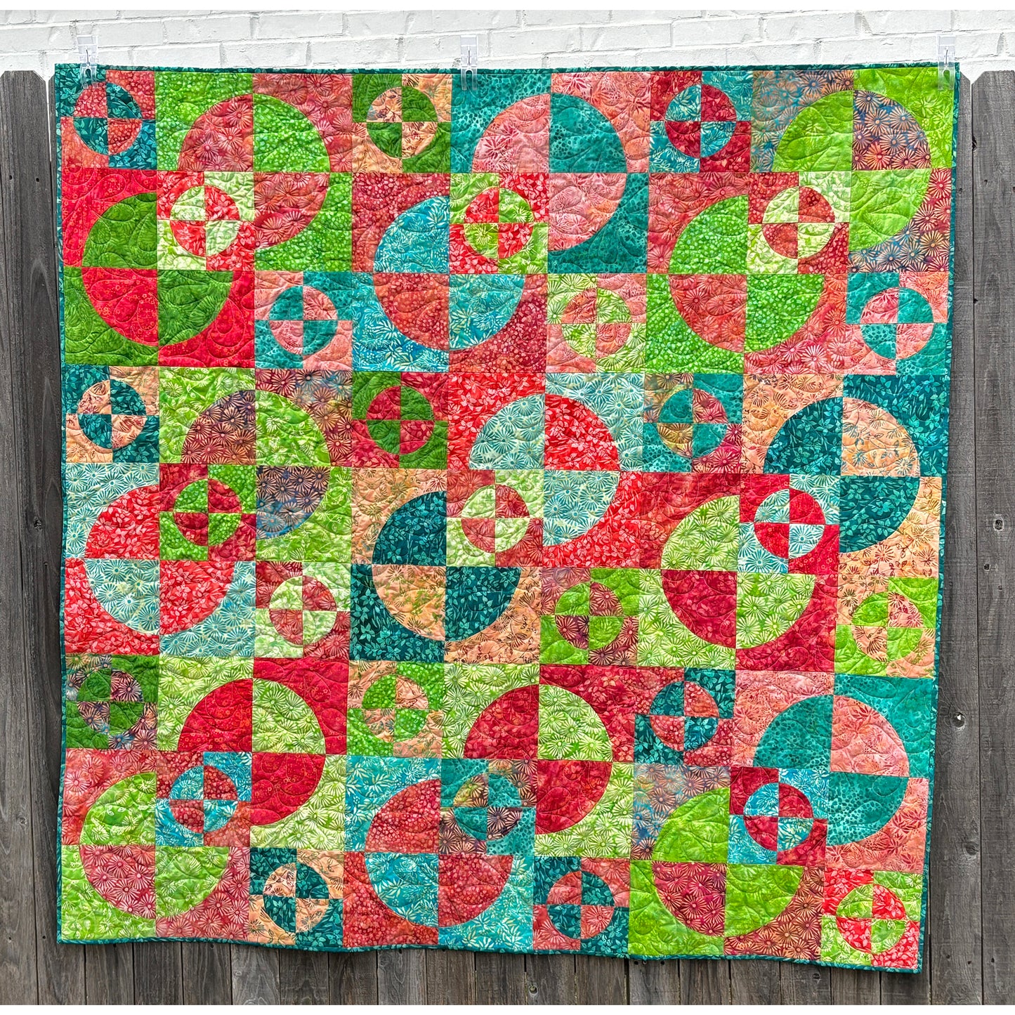 Fun circles in circles with pie shaped colors of different fabrics quilt.