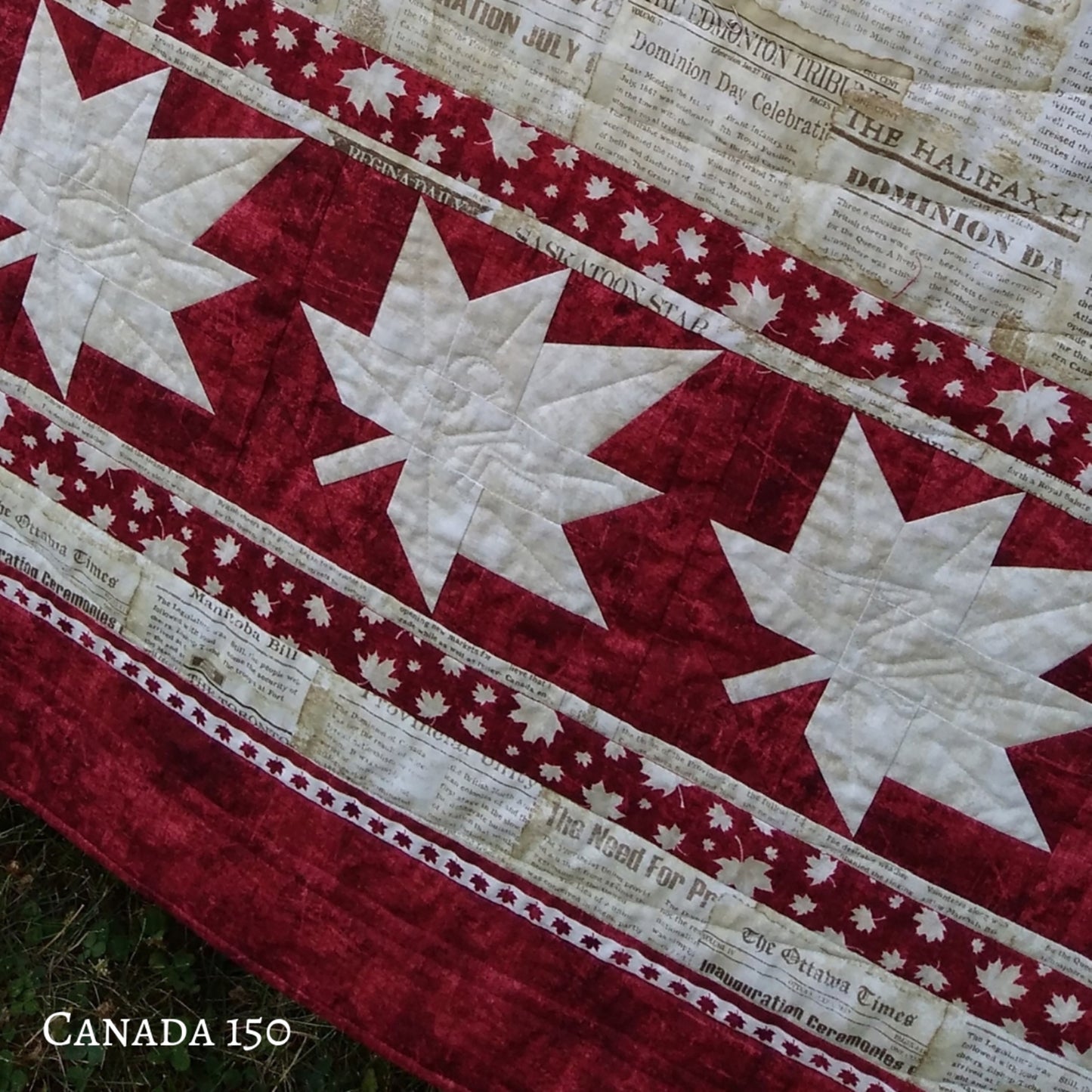 Closeup of the quilt border of white maple leaves. Shows the fun details including fabric used for this example quilt.