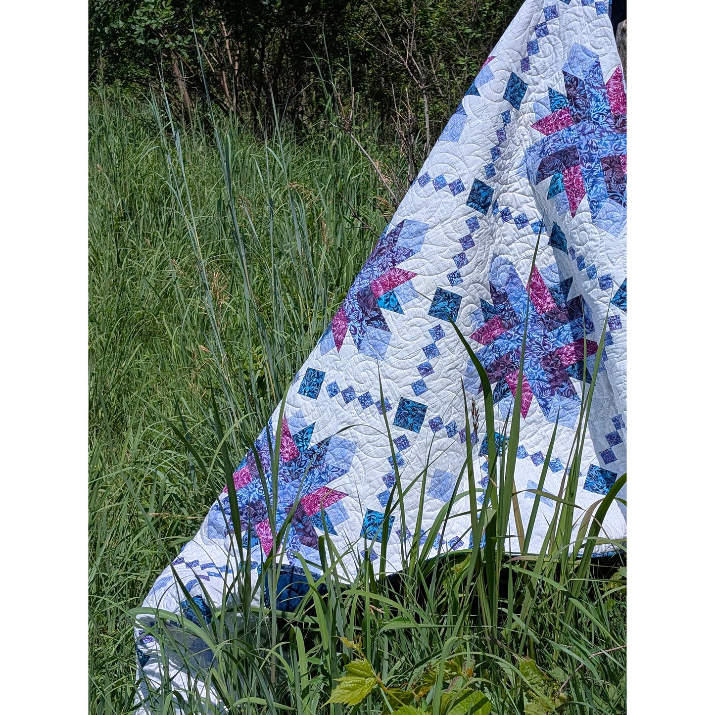 Shining Lace quilt features delicate strip-pieced chains surround elegant starburst blooms.