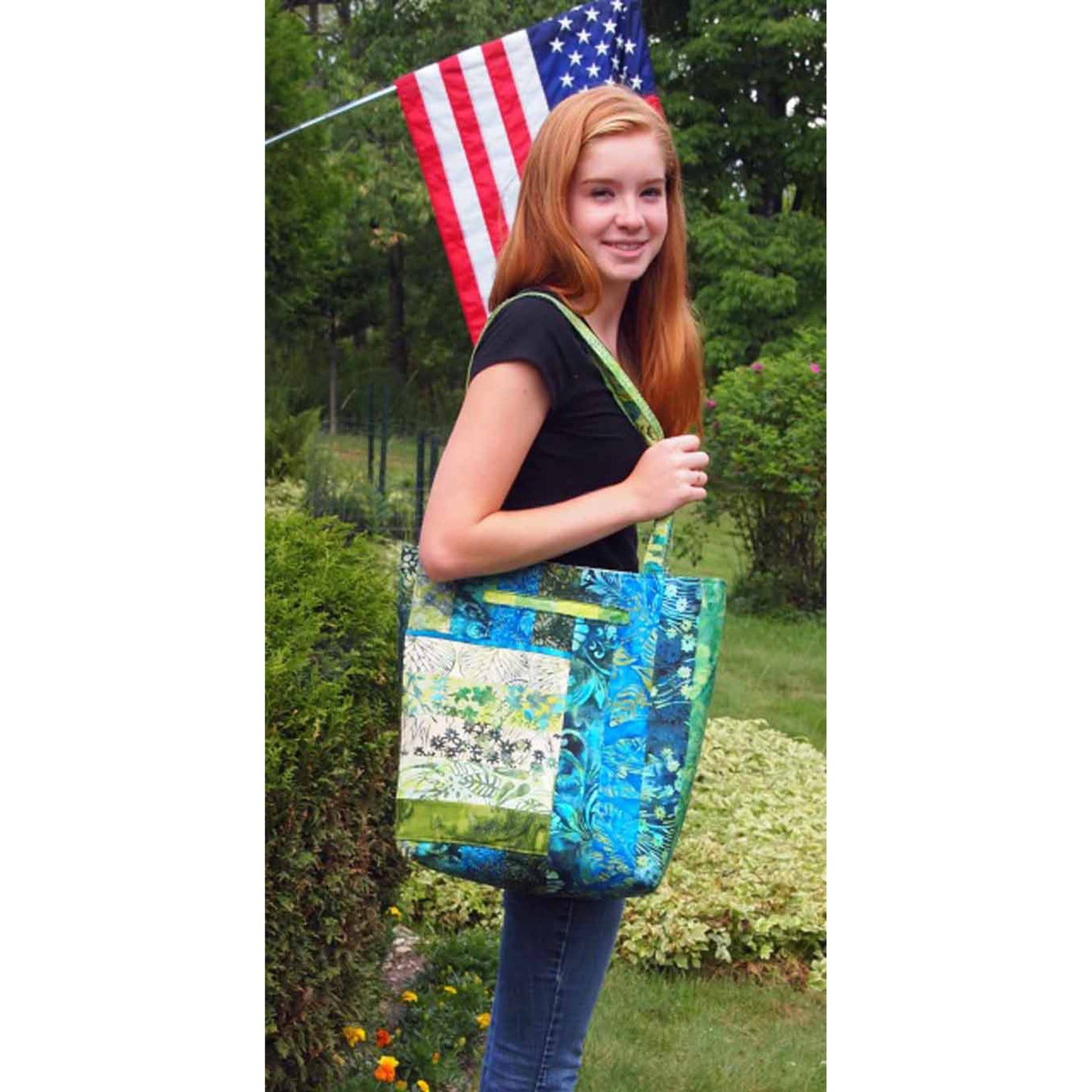 Young lady holding the Stripper's 40 tote bag over her shoulder. Shows how large it is.