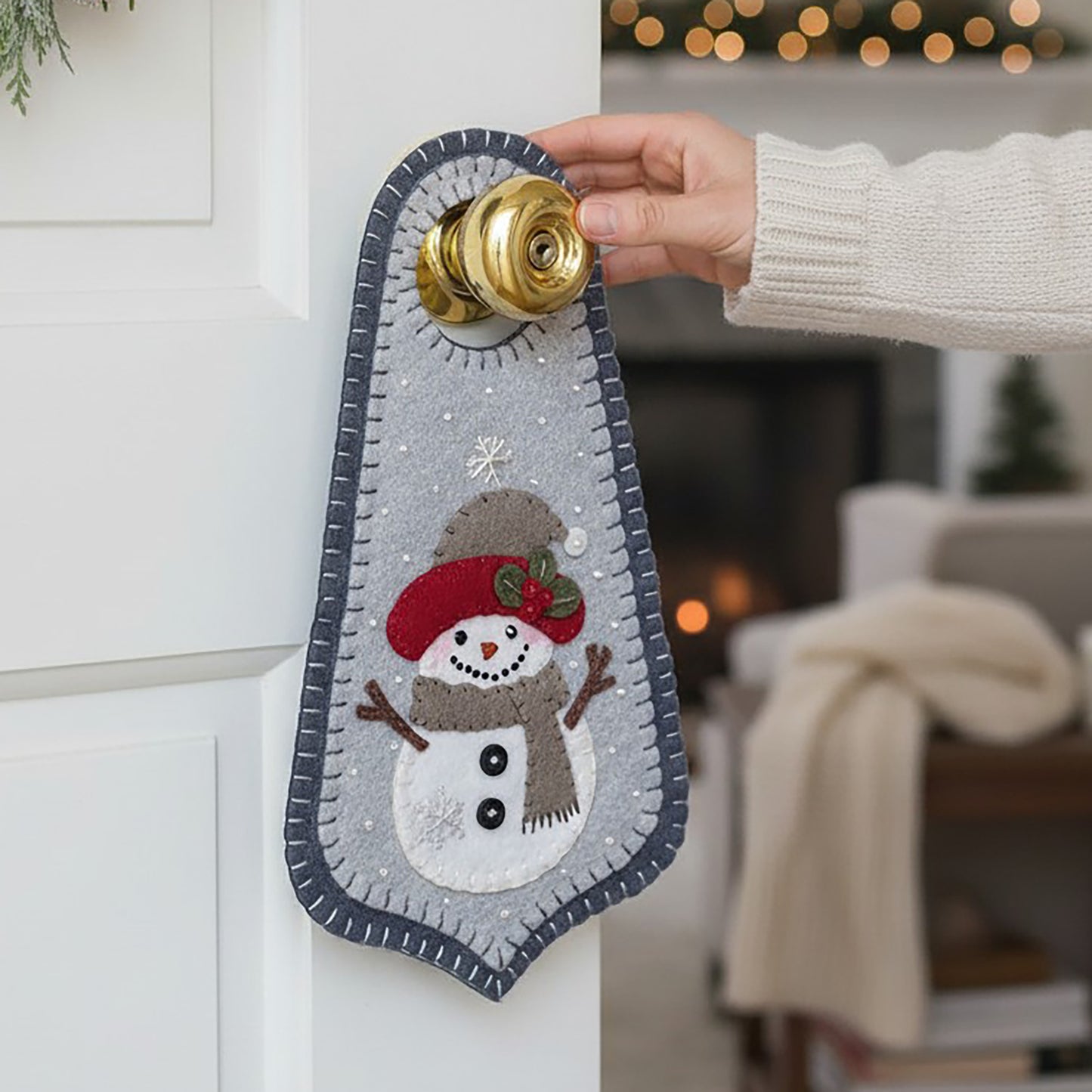 Welcome the first snowfall of the season with this happy little snowman Doorknob hanger. Snowman is wearing a hat and scarf with buttons on his chest.