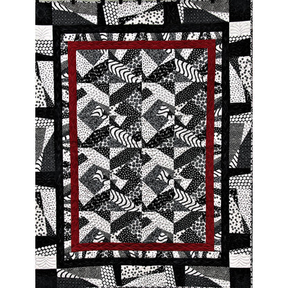 Quilt with geometric pattern and red border on a white background
