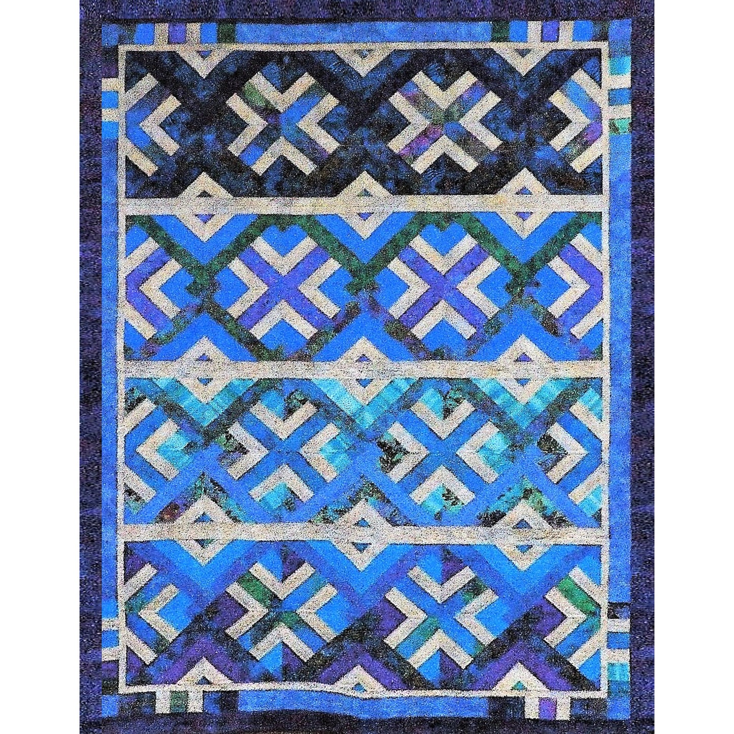 Quilt with geometric pattern in blue, black, and white on a dark background