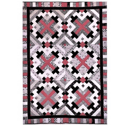 Quilt with geometric pattern featuring red, black, and white on a white background