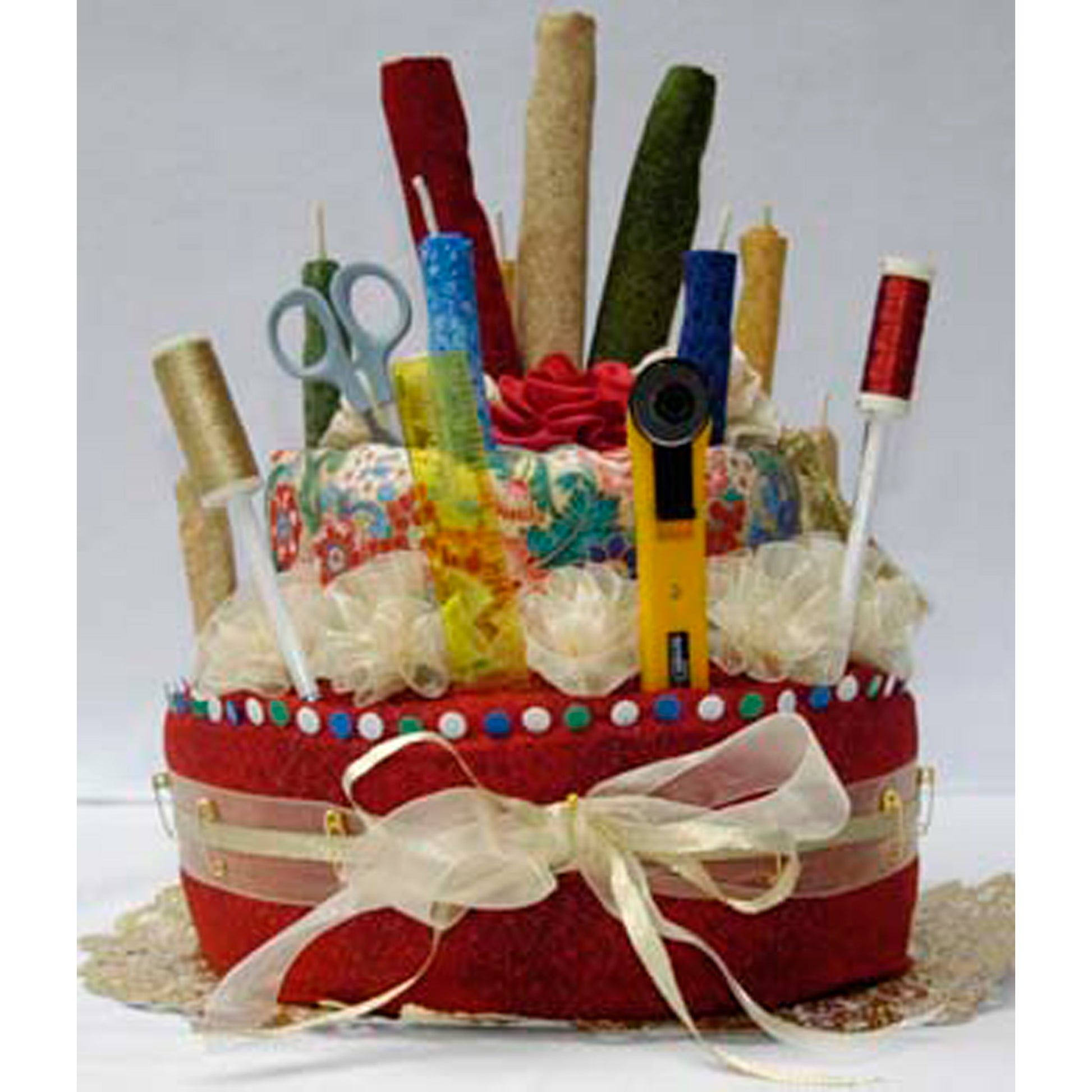 Decorative fabric "cake" with stationery items on a white background