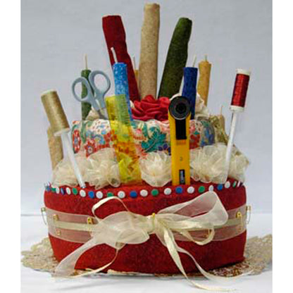 Decorative fabric "cake" with stationery items on a white background