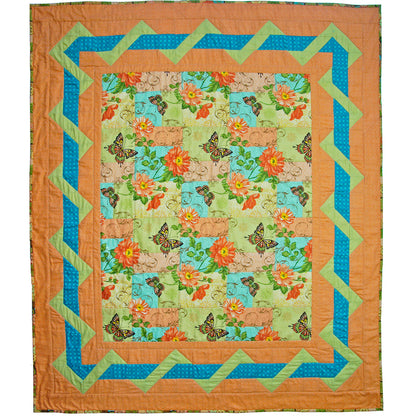 Quilt with butterfly and floral pattern on a white background