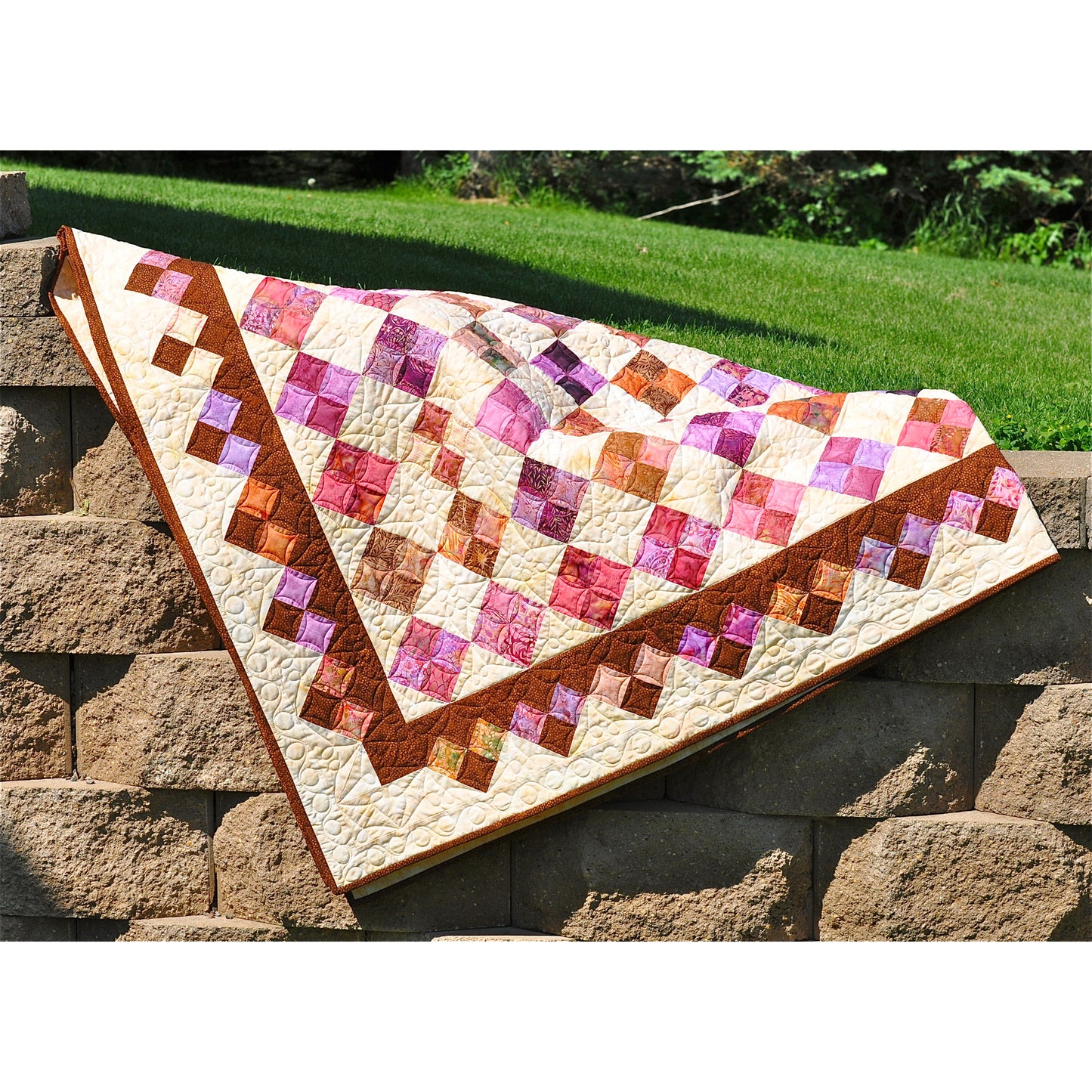 Quilt with a geometric pattern on a stone surface