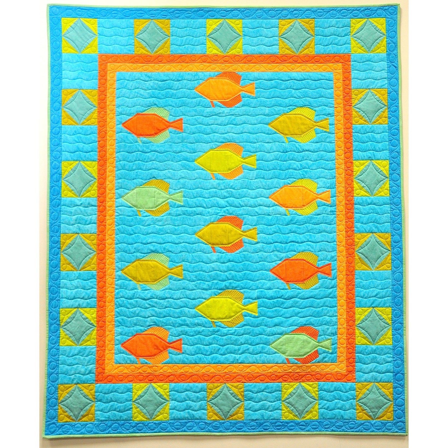 Quilt with fish pattern on a blue background