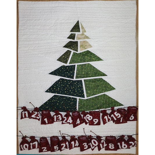 Fun quilt block features a blocky Pine Tree looking like it's stacked with rotating levels and a string with bags of numbers below for an advent calendar. Each bag holding an ornament to decorate the tree.