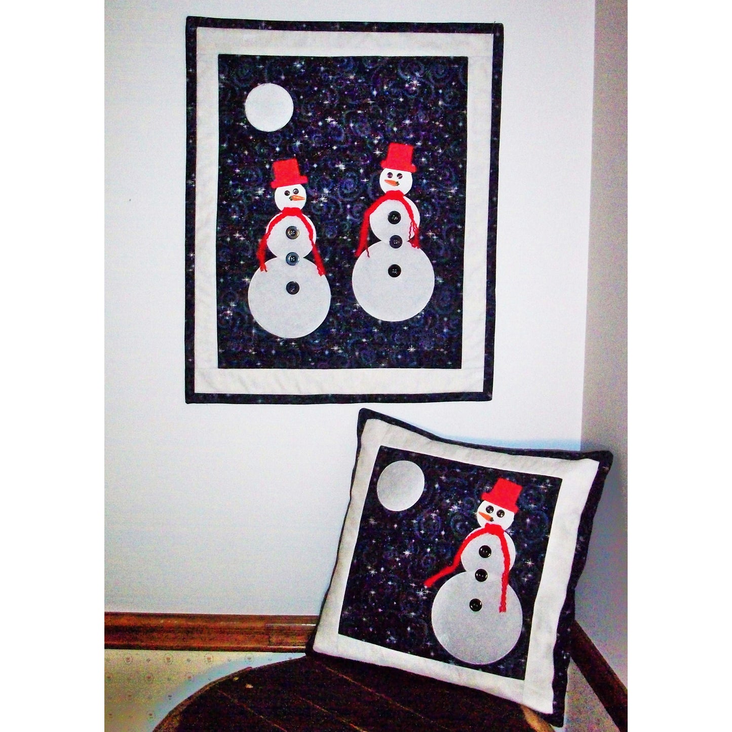 Moonlit Snowmen quilt and matching pillow is a must have for the winter season. Cute, appliqued snowmen stand out on a cold winter night gazing at the moon. The pillow has one snowman.