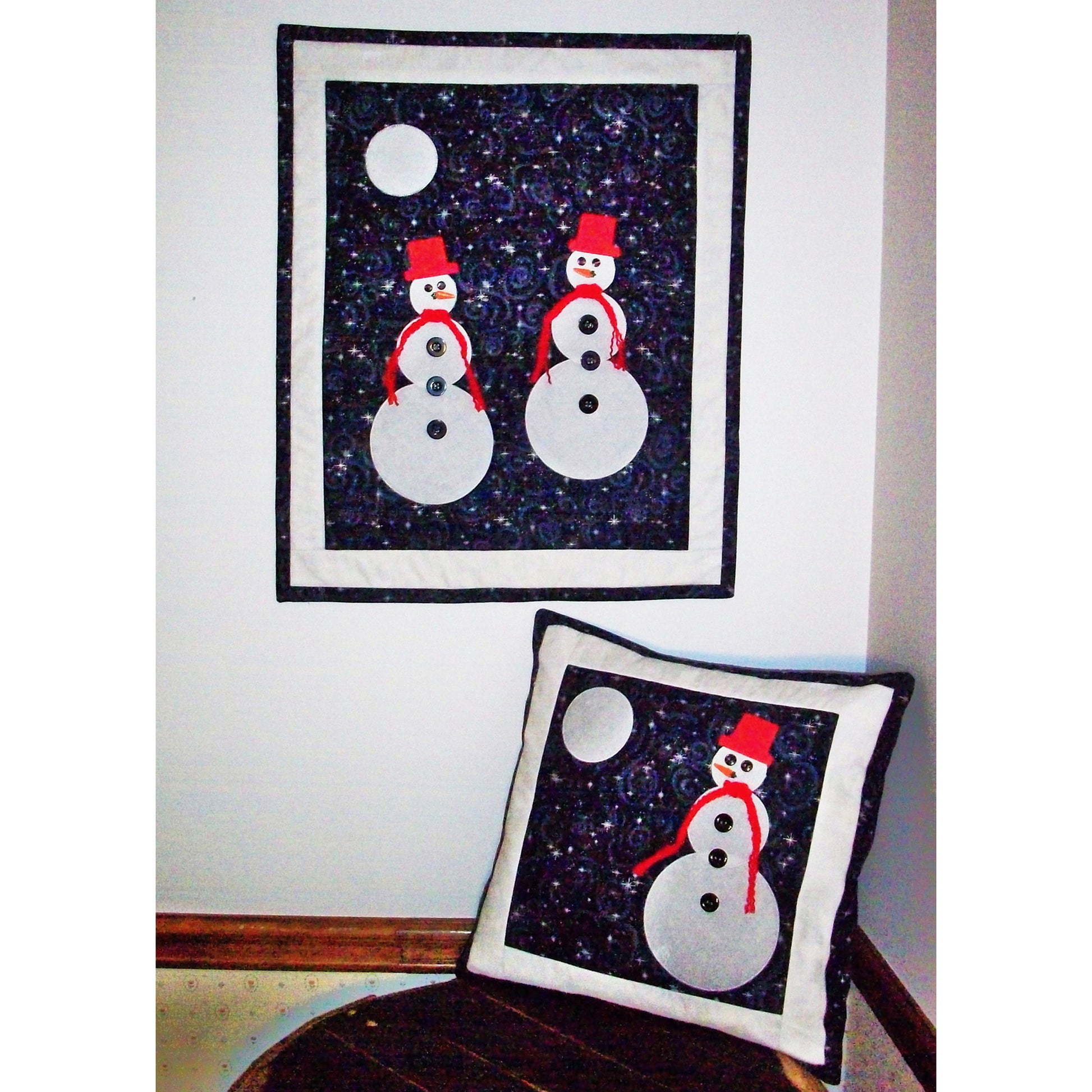 Moonlit Snowmen quilt and matching pillow is a must have for the winter season. Cute, appliqued snowmen stand out on a cold winter night gazing at the moon. The pillow has one snowman.