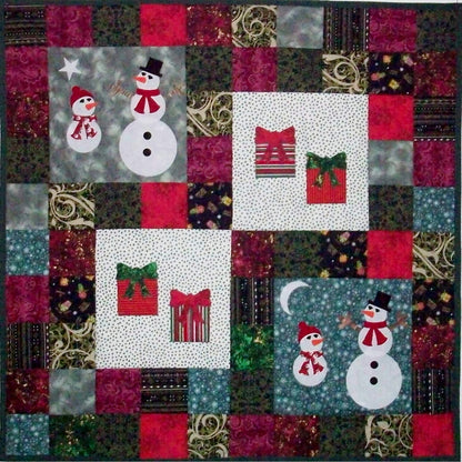 Adorable table topper includes four blocks with snowmen in two and presents in the other two.  The rest is scrappy with holiday fabric.