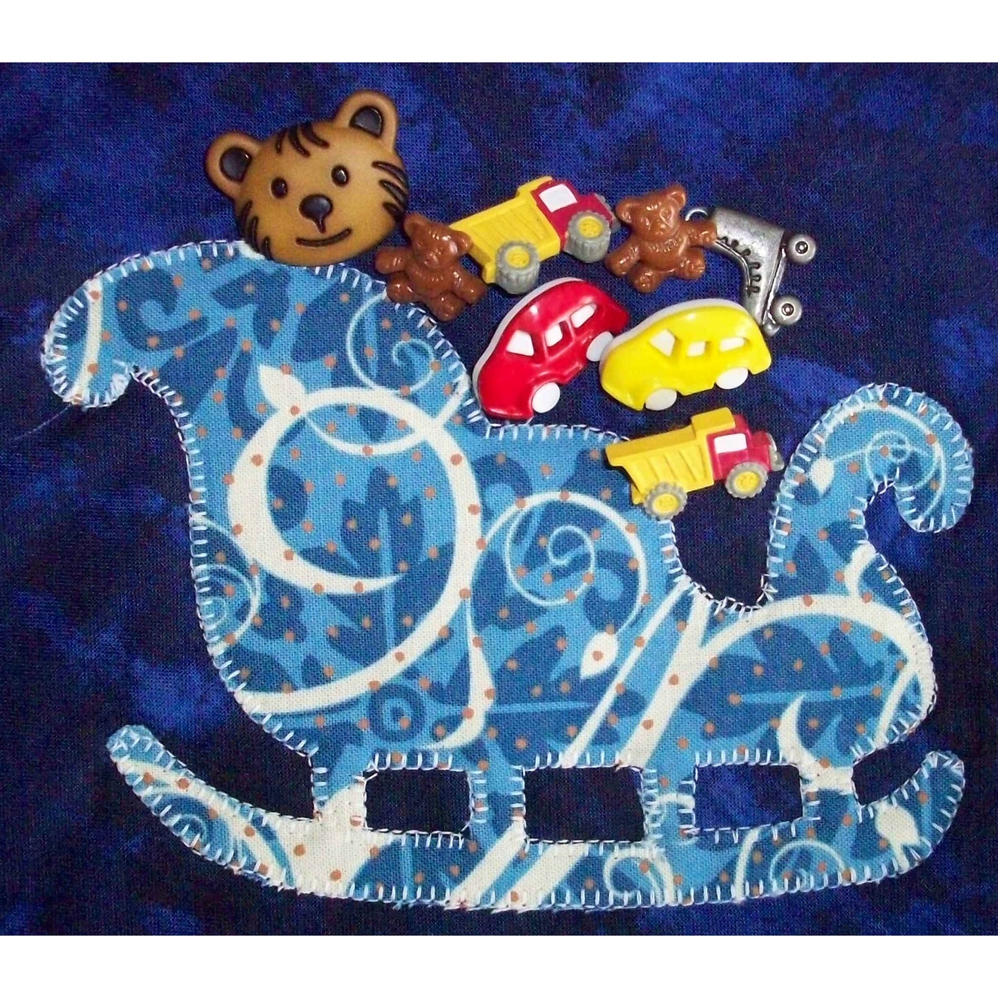 Close up of the sleigh in the quilt to show how you can use toy buttons to fill the sleigh.