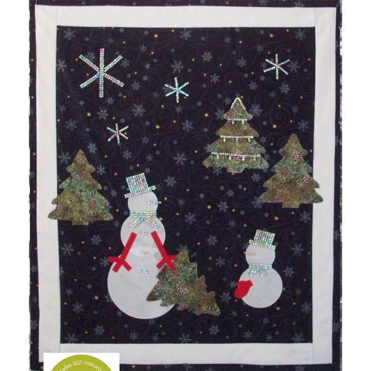 Cute winter scene wall quilt featuring snowmen and Christmas trees. 