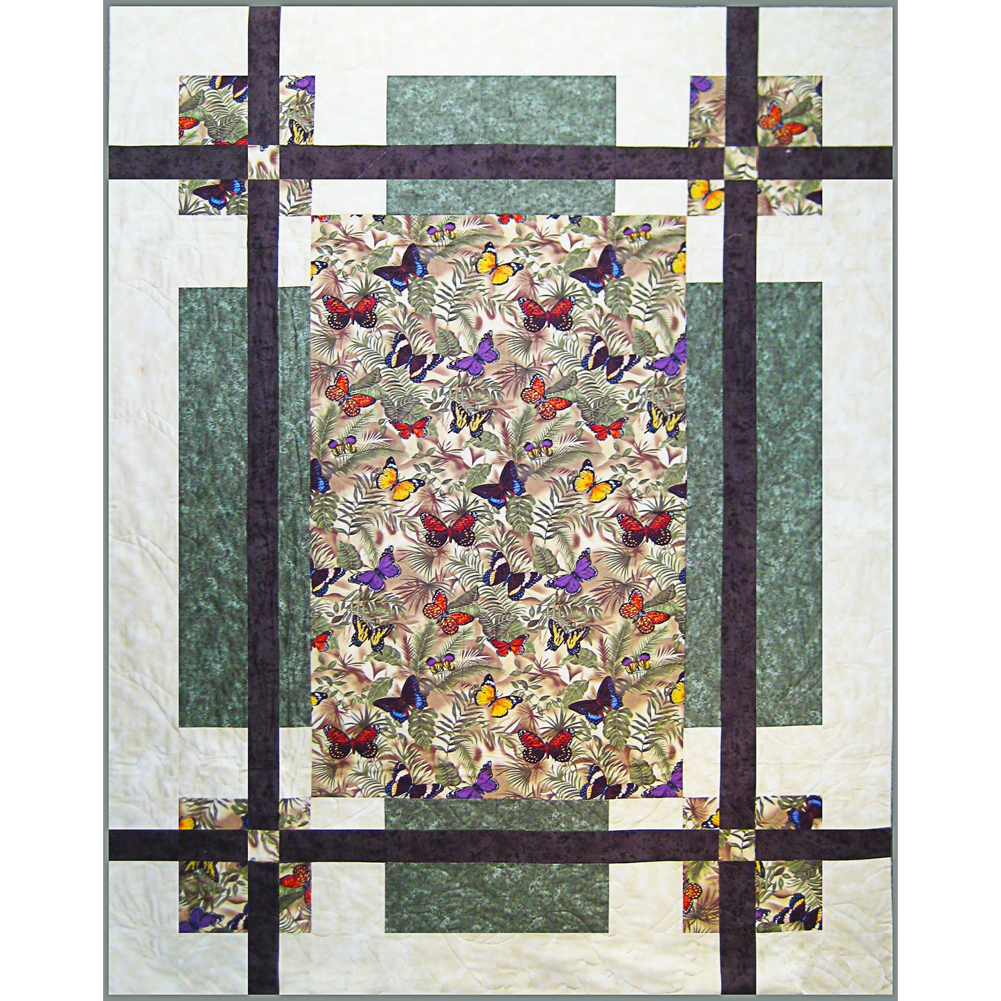 Quilt with butterfly pattern and geometric design on a white background