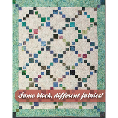 Fun quilt features colorful diagonals of colorful diamonds on a neutral background.