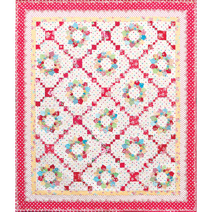 Beautiful quilt features diamonds of wreaths of hearts in a scrappy feel with different sized diamond strands separating these diamonds.