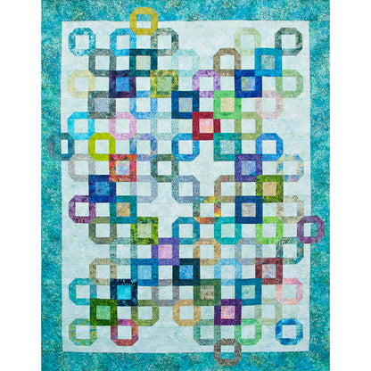 Fun quilt features open blocks on a neutral background with some with different colors inside them. The design of where the blocks are placed seems random.