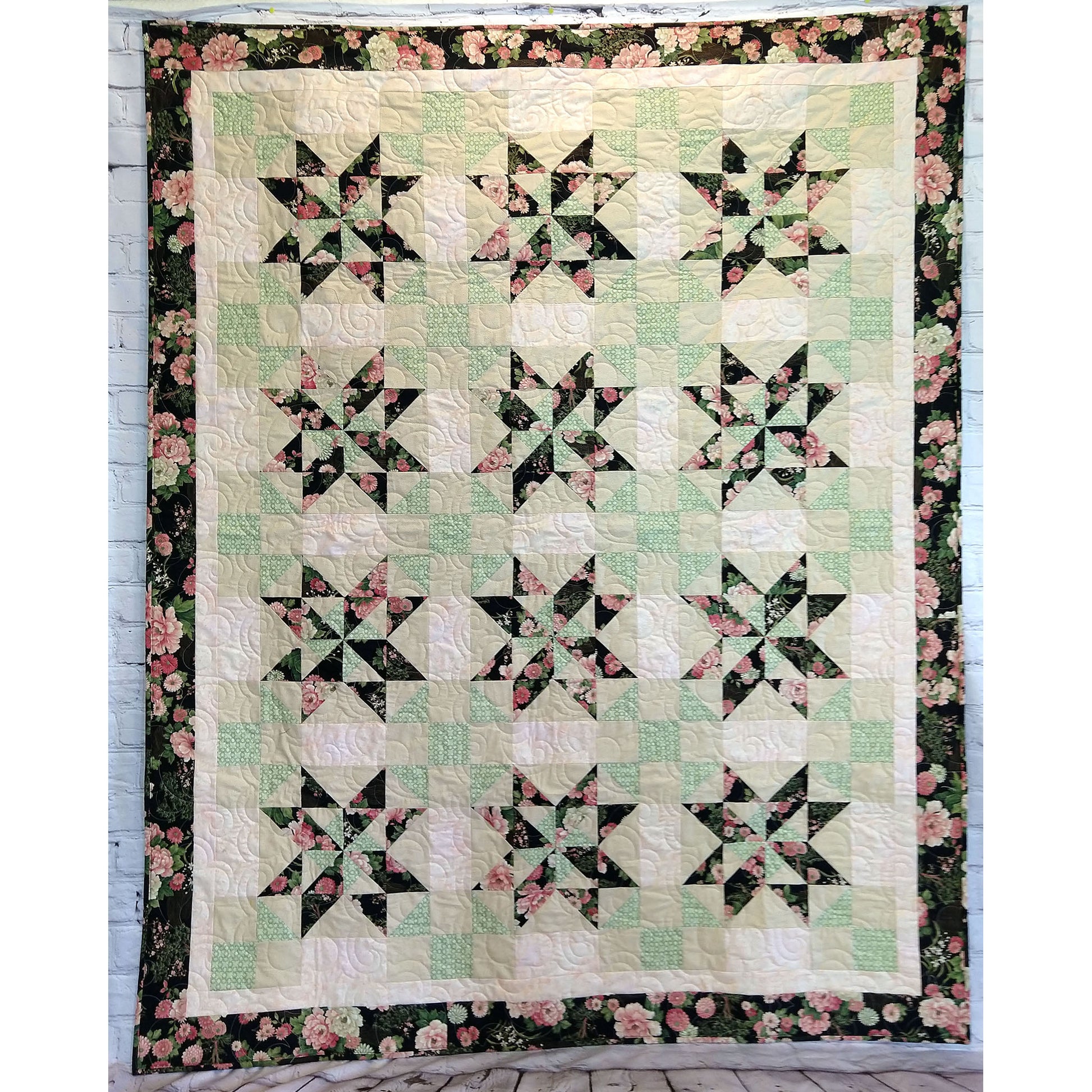 Zen Garden quilt features pretty pinwheel stars.