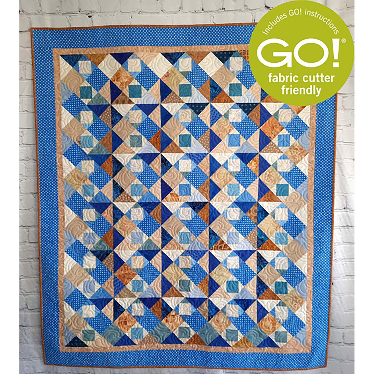 Fun scrappy quilt features blues and brown in a patchwork of squares.