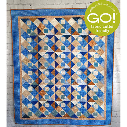 Fun scrappy quilt features blues and brown in a patchwork of squares.