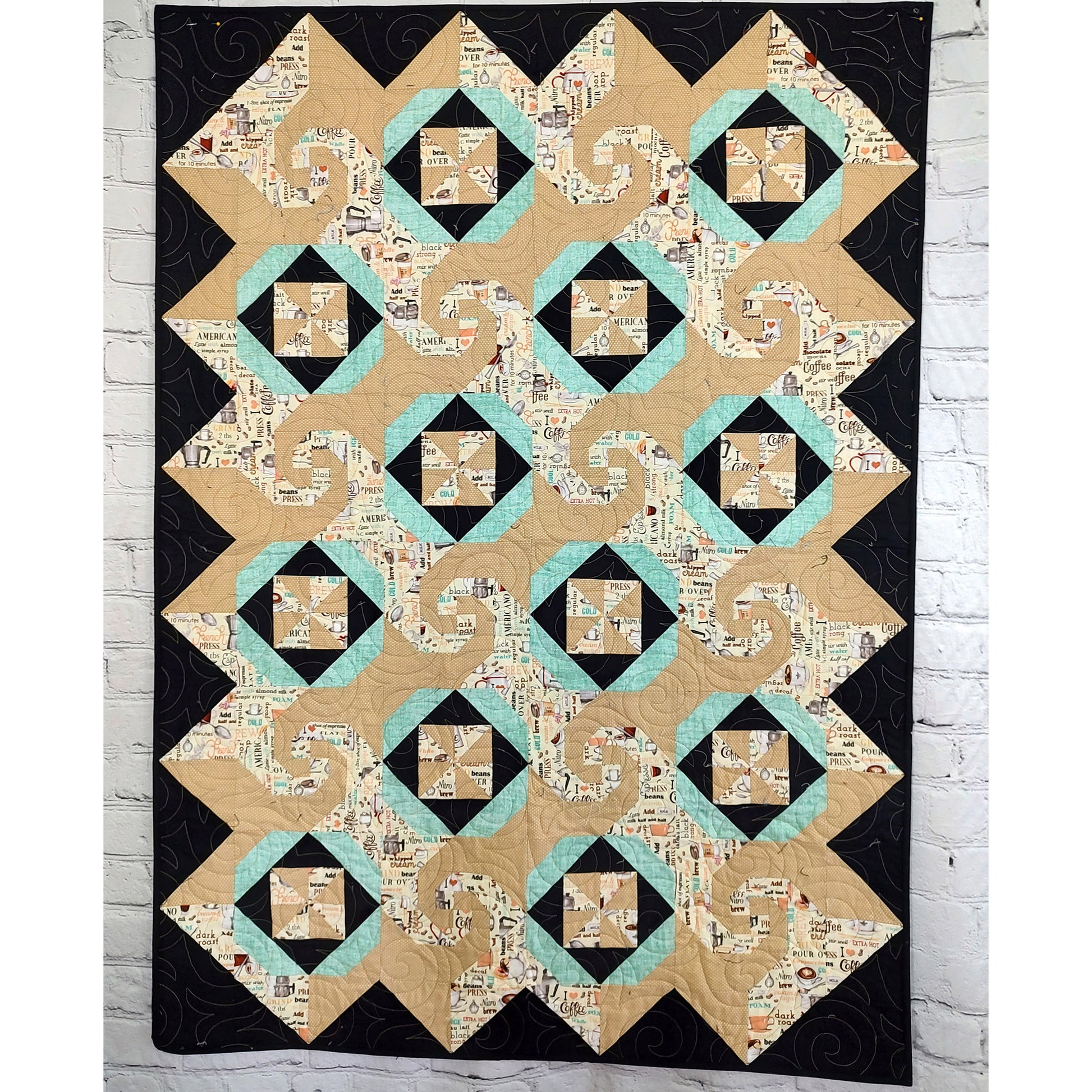 Cafe Latte quilt features squares of swirls, like on a latte made at a shop, pinwheel blocks, and thimble looking blocks.