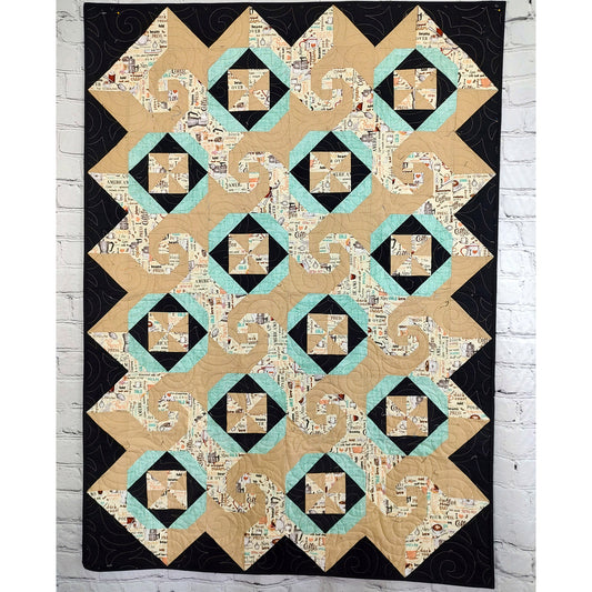 Cafe Latte quilt features squares of swirls, like on a latte made at a shop, pinwheel blocks, and thimble looking blocks.