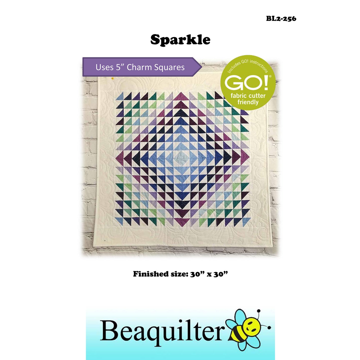 Colorful quilt with purple and green triangle design with note about this pattern being Accuquilt GO! fabric cutter friendly and that it uses 5-inch charm squares.