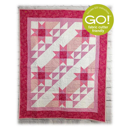 Beautiful quilt in pinks and white fabric with stars and diagnal rows of white, pinks and white and pink triangles.