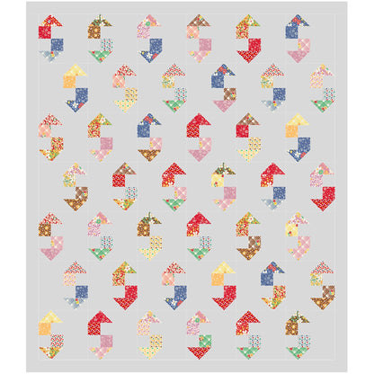 A vibrant quilt featuring an array of colorful shapes, which could look like a wrench, on a gray background.