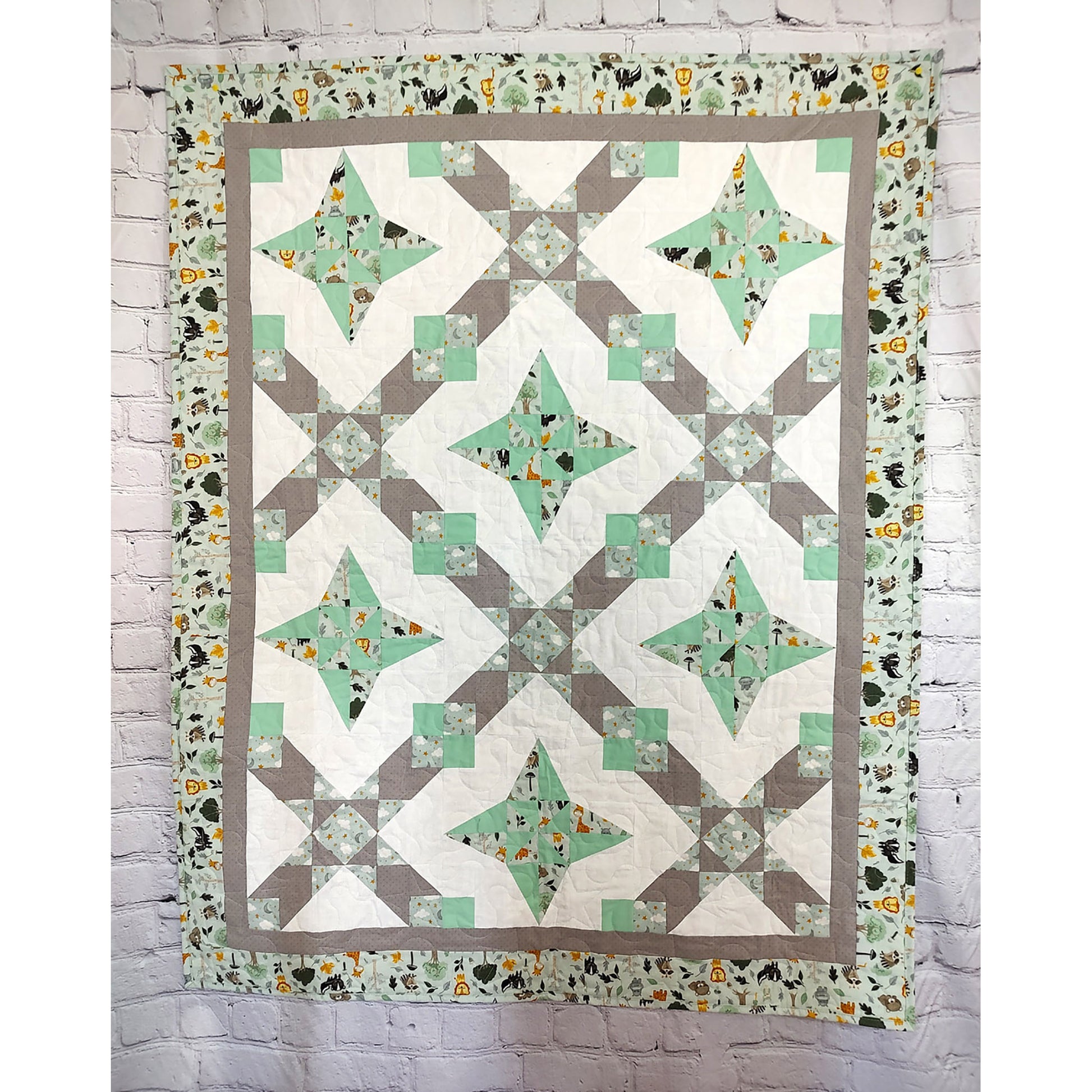 A geometric quilt featuring a harmonious blend of green and gray patterns.