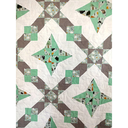 A geometric quilt featuring a harmonious blend of green and gray patterns.