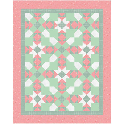 A colorful quilt in red and green, adorned with a continuing star pattern. With the colors, it seems like a Christmas Quilt.