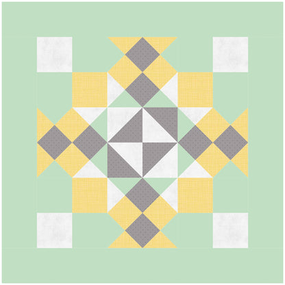 A quilt featuring a pattern of yellow, green, and gray squares arranged in a harmonious design. One block of design.