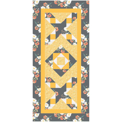 Two element table runner features an X with a friendship star in the middle on the top and bottom with a square inside a square design in the middle.  The color scheme is yellow with complementing fabrics with flowers.