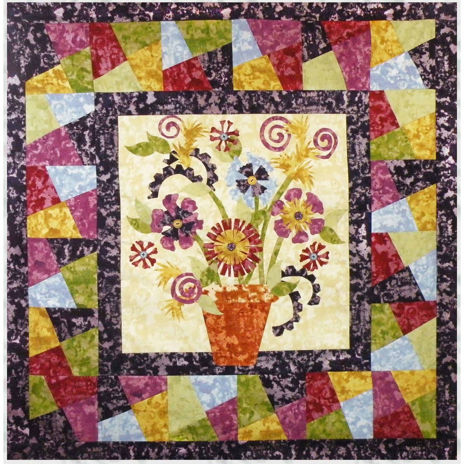 Beautiful fancy flowers in a pot quilt. The border is pieced bright colors which almost looks like stained glass.