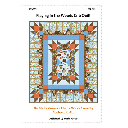 Quilt pattern cover titled 'Playing In the Woods Crib Quilt' with colorful design and text.