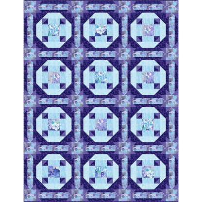 Quilt with blue and purple geometric pattern on a white background