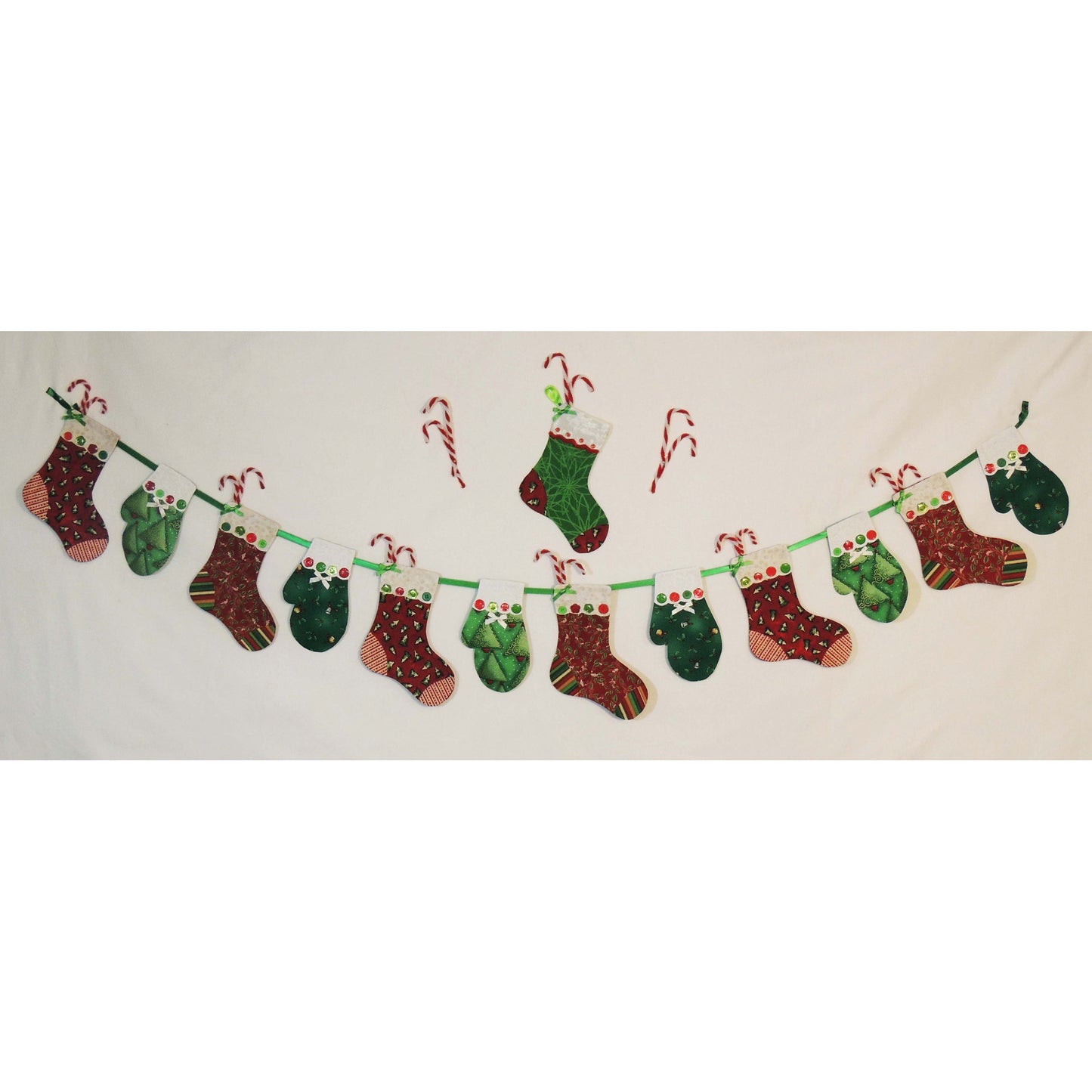 Stockings and Mittens Garland in Christmas fabrics with a single stocking on top.
