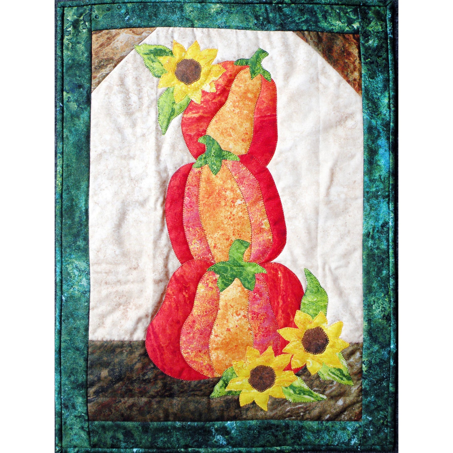 Adorable wall hanging quilt with three stacked pumpkins with a few sunflowers around them.