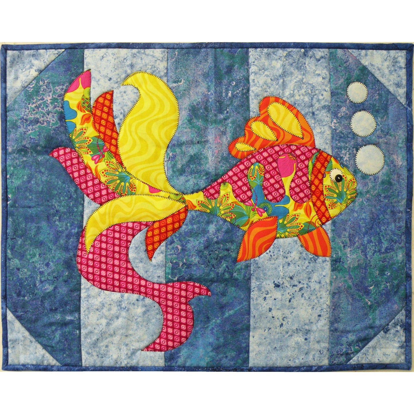 Colorful fish quilt with a blue and white patterned background