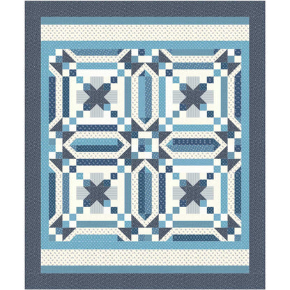 Quilt with blue and white geometric pattern on a white background