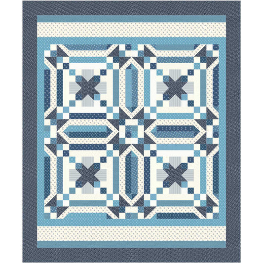 Quilt with blue and white geometric pattern on a white background